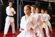Girl practicing new moves during karate class